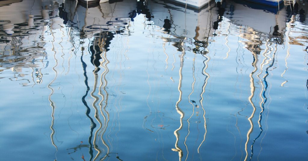 Background with boats reflection in Adriatic Sea Pula Croatia